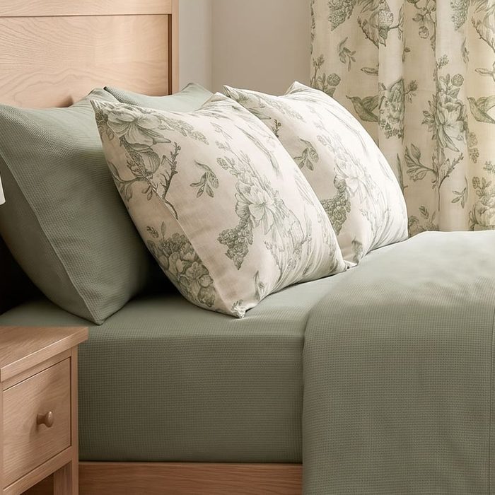 Toile pillowcases on sage sheets